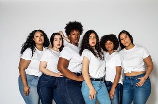 seis mulheres usando calça jeans e camiseta branca